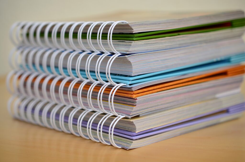A stack of ring-bound books, representing the challenges that documentation can impose on reducing cycle time.